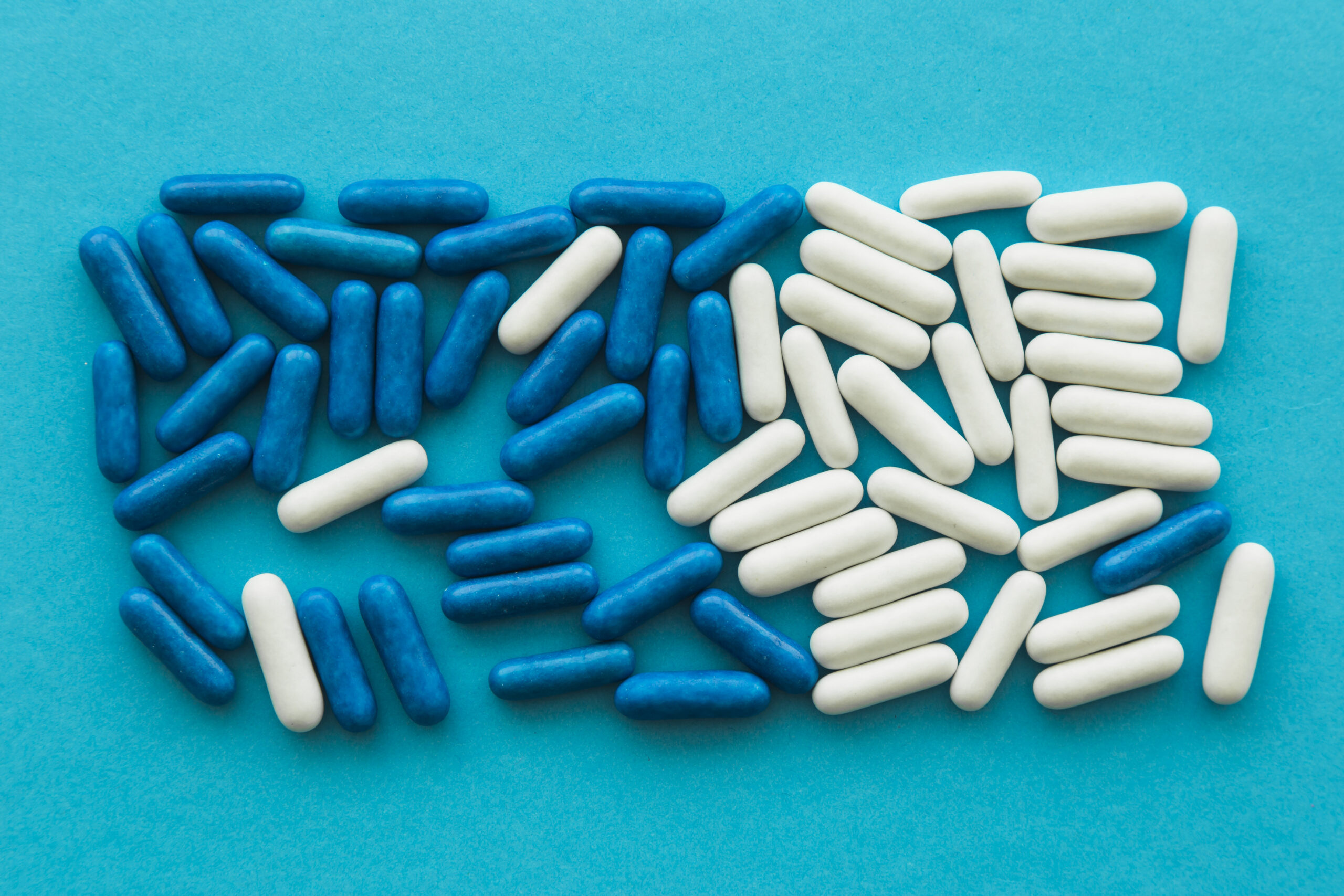 high-angle-view-candy-capsules-blue-background